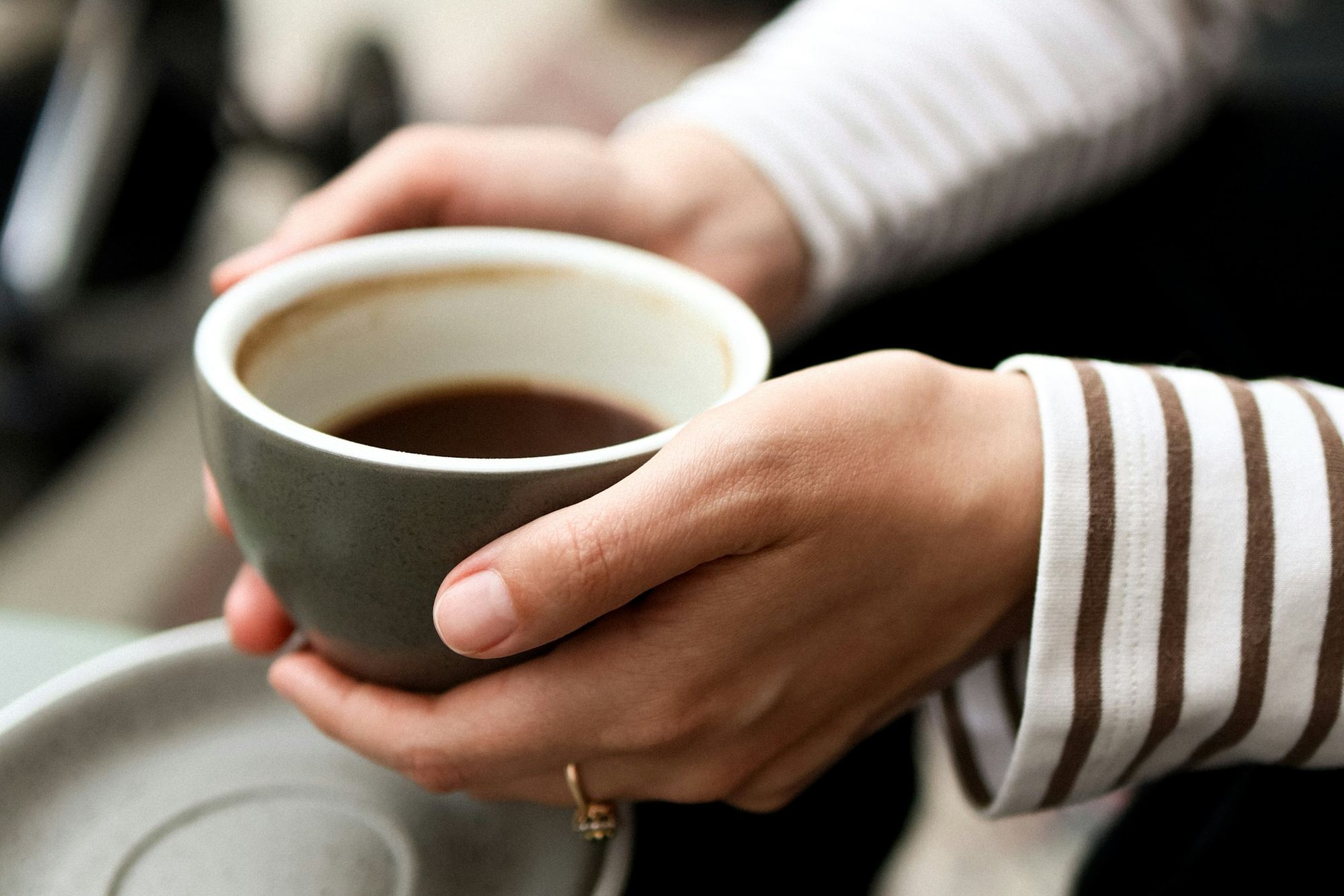 Two hands holding a warm cup